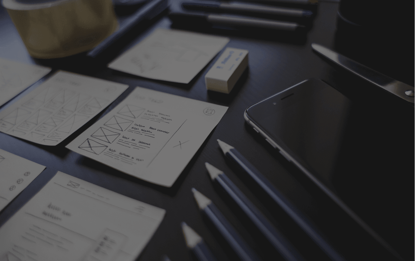 Table with sharpened pencils and business documents to show Integrity's expertise with B2B marketing